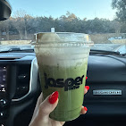 Iced Jasper matcha latte enjoyed in a freshly washed car